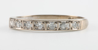 An 18ct white gold diamond half hoop ring, Size J