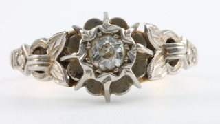 An 18ct yellow gold single stone diamond ring with floral mount, Size K