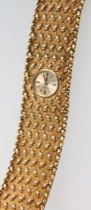 A ladys 9ct yellow gold Omega wristwatch on a fancy 9ct yellow gold wide bracelet 48g Boxed