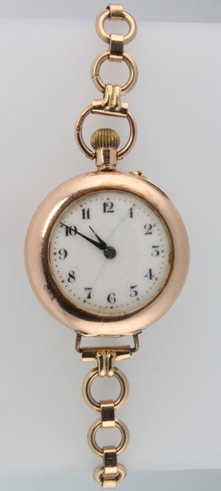 A lady's 9ct yellow gold wrist watch on a gilt bracelet a'jewel' set plated ditto