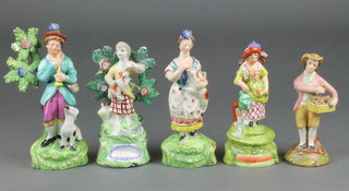A 19th Century English porcelain figure of a flute player and his dog 6 1/2" together with 4 similar figures