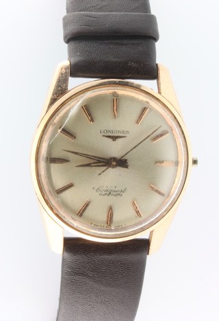 A gentleman's gilt cased Longines Conquest automatic wrist watch on a leather strap