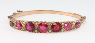 A Victorian 9ct gold gem set bangle with diamond chips, 13 grams
