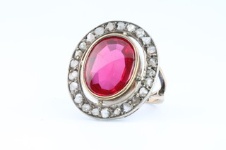 A 19th Century yellow gold oval ruby and 24 stone diamond ring, size L 