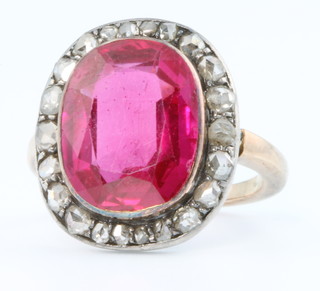 A 19th Century ruby and diamond cluster ring, the centre oval cut stone surrounded by 21 diamonds, size K 