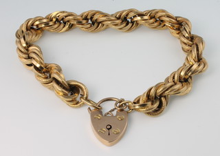 An 18ct fancy link bracelet with 9ct gold padlock, 23 grams