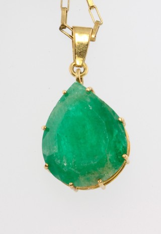 A gold pear shaped emerald pendant on a 9ct gold chain, the emerald approx. 21.5mm x 17mm 