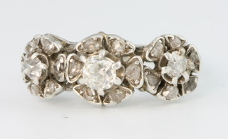 An 18ct white gold triple cluster diamond ring, size O
