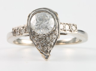 A 14ct white gold pear shaped diamond ring with a large stone approx 0.5ct and 8 smaller stones making up the pear, with 3 diamonds to each shoulder, size N