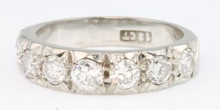 An 18ct white gold 7 stone diamond half eternity ring, size N 