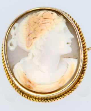 A gold coloured portrait cameo brooch with locket back
