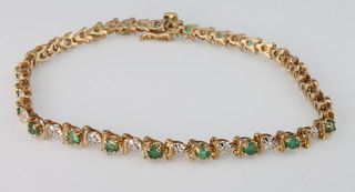 A 9ct yellow gold diamond and emerald bracelet 
