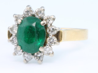 An 18ct yellow gold emerald and diamond oval cluster ring size G