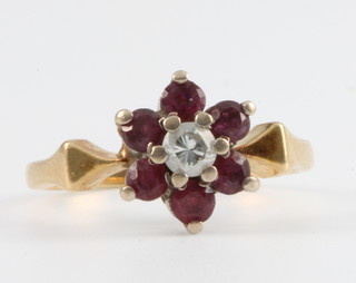An 18ct yellow gold ruby and diamond ring size G