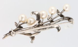 A Mikimoto silver pearl set brooch and earrings
