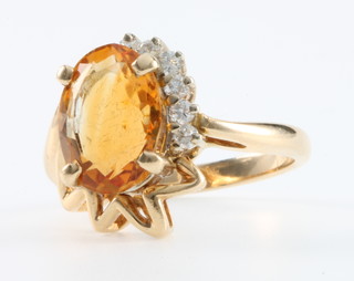 A 14k yellow gold oval cut citrine (approx 5.5ct)  and diamond open dress ring Size L