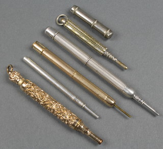 A gilt propelling pencil and 4 others
