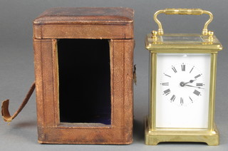 A carriage timepiece with enamelled dial and Roman numerals contained in a gilt metal case complete with leather carrying case 