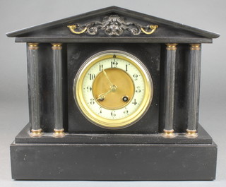 A Victorian French 8 day striking mantel clock with enamelled dial and Arabic numerals contained in a black marble architectural case 