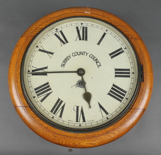A 19th Century fusee wall clock, the 12" painted dial with Roman numerals, marked Surrey County Council, having a 4 1/2" brass black plate, contained in an oak case 