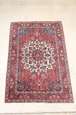 A Persian Bakhtiari blue and white rug with central medallion 34" x 56" 