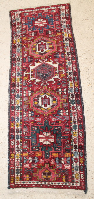 A Persian Karajeh red and white ground runner 66" x 24" 
