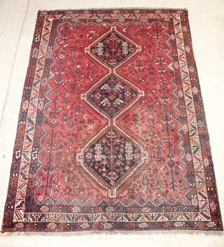 A red and white ground Persian Qashqai carpet with 3 diamonds to the centre 119" x 88" 