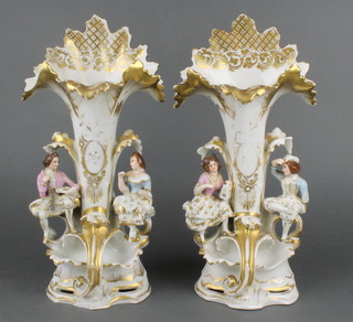 A pair of 19th Century Paris Porcelain spill vases decorated seated figures on rococo bases 14"  
