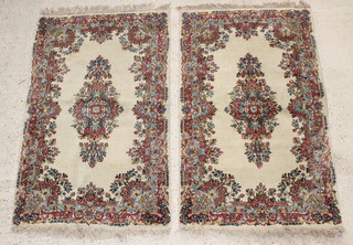 A pair of white and floral ground Persian rugs 59" x 36"  