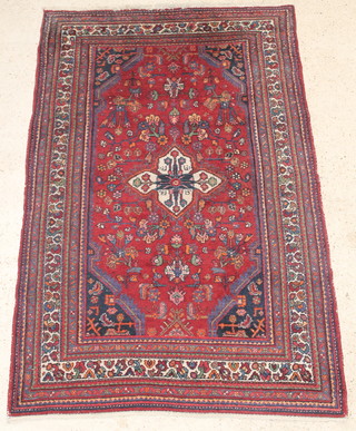 A Persian Brojerd red ground rug with central medallion within multi-row borders 78" x 53" 