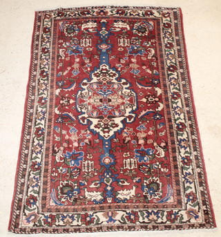 A brown and blue Persian rug with central medallion 84" x 58" 
