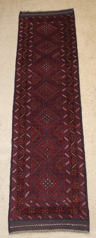 A contemporary blue and red ground Meshwani runner with 7 diamonds to the centre 97" x 27" 