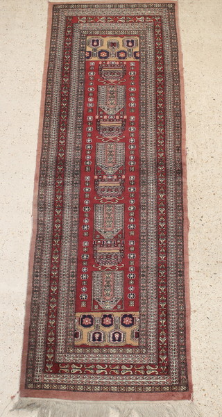 A brown ground Bokhara runner with 4 rectangular medallions to the centre 97" x 32 1/2"  