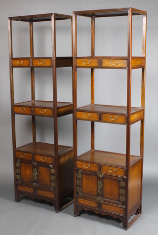 A pair of mid 20th Century Padouk wood 3 tier display stands, each with 6 short drawers and cupboard doors, raised on bracket feet 74 1/2"h x 21 1/2"w x 14 1/2"d