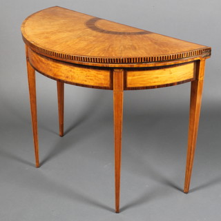A 19th Century Sheraton style inlaid and crossbanded satinwood D shaped card table on square tapered legs 30"h x 39"w x 19"d 