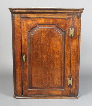 A Georgian oak corner cupboard with panelled door and H brass hinges, 58 1/2"h x 29"w x 16"d 