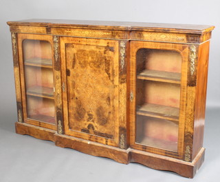 A mid Victorian inlaid walnut breakfront Credenza with inlaid geometric scrolls, the centre panel door flanked by arch glazed doors, having gilt metal mounts raised on a plinth base 44"h x 72"w x 15"d 