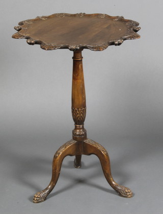 A Georgian style circular carved oak snap top wine table with pie crust edge, raised on turned column and tripod base 27"h x 20" diam. 
 