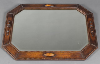 An Art Deco lozenge shaped plate mirror contained in a carved oak frame 23"h x 30"w 