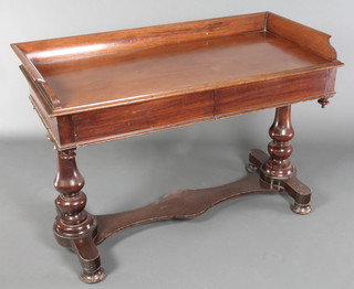 A Victorian mahogany wash stand/dressing table with three-quarter gallery fitted 2 drawers, raised on turned supports with shaped stretcher 33"h x 49"w x 27 1/2"d 