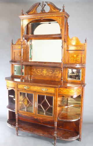 An Edwardian inlaid rosewood chiffonier sideboard with raised mirrored back fitted adjustable shelves, the base fitted a drawer above a cupboard enclosed by glazed panelled doors and with niches to the sides 90"h x 59"w x 17"d 