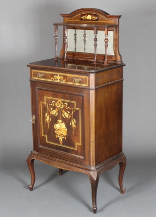 An Edwardian inlaid mahogany music cabinet with raised mirrored back, the base fitted a drawer above a cupboard enclosed by panelled door inlaid musical trophies, raised on cabriole supports 54"h x 24"w x 16"d 