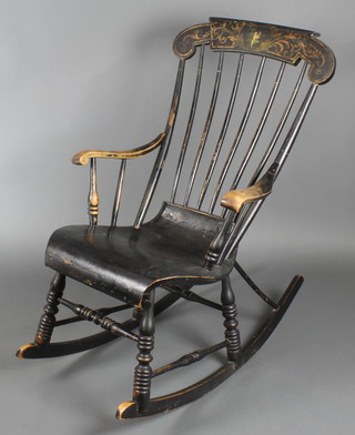 A Victorian black painted stick and bar back rocking arm chair