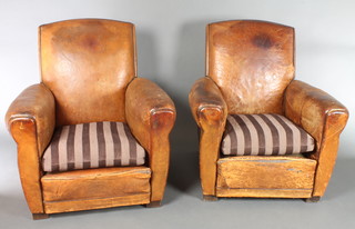 A pair of 1920's club style armchairs upholstered in brown leather 
