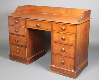 A Victorian mahogany kneehole pedestal dressing table/desk with raised three quarter gallery, fitted 1 long and 6 short drawers with tore handles, raised on a platform base 33"h x 46"w x 19"d 