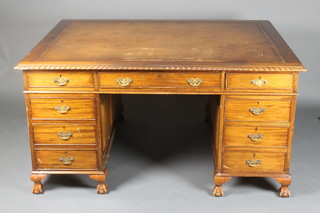 A Chippendale style mahogany partners desk with brown inset writing surface above 1 long and 8 short drawers and fitted cupboards to one side of the pedestals, raised on cabriole supports 30"h x 59"w x 48"d