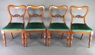 A set of 4 Victorian mahogany buckle back dining chairs with shaped mid rails and upholstered seats, raised on turned supports, some with signs of old but treated worm 