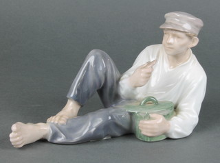A Royal Copenhagen figure of a reclining fisherman eating a biscuit 865 8" 