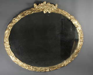 An oval plate wall mirror contained in a decorative gilt frame 42" x 49" 