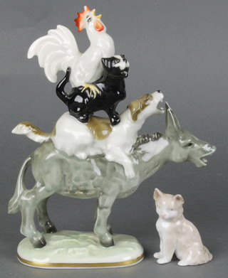 An unusual German porcelain group "The Town Musicians of Bremen"  a cockerel sitting on a cat, sitting on a dog, sitting on a mule 7 1/2" together with a Lladro figure of a cat 2 1/2" 